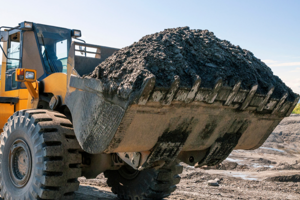 A heavy machinery bucket full of gravel